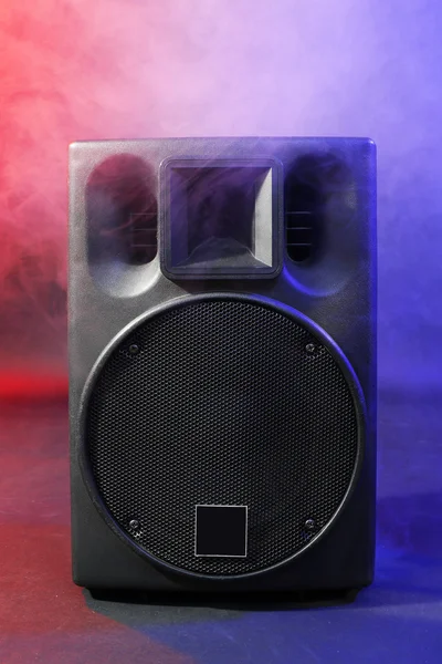 Black loudspeaker in a smoke on dark background — Stock Photo, Image