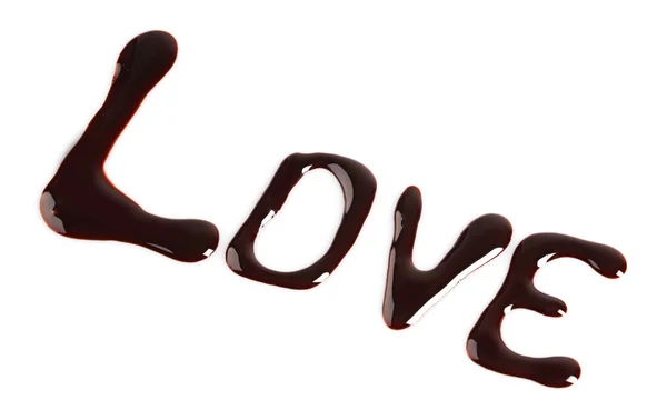 Een woord "love", geschreven met chocolade, geïsoleerd op wit — Stockfoto