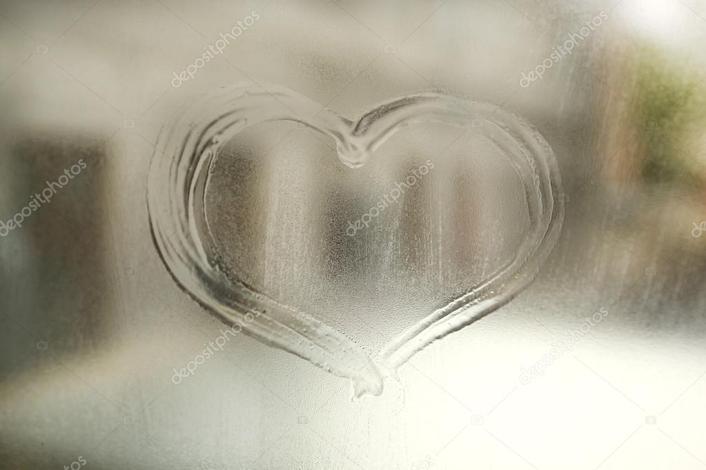 Heart drawn on the fogged glass window