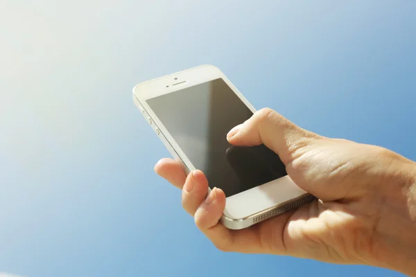 Female hand holding smartphone — Stock Photo, Image