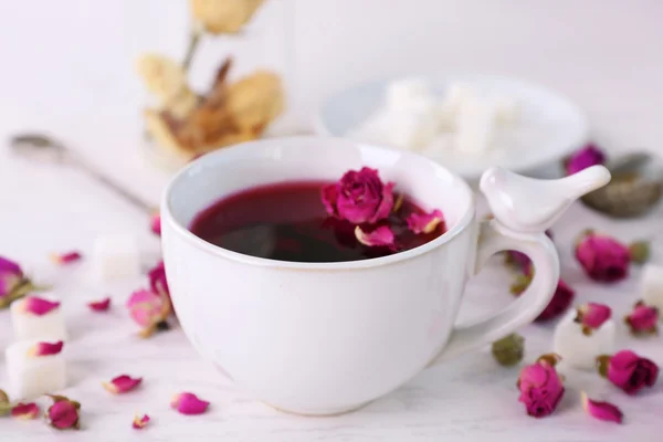 Chá e chá rosa flores na mesa closeup — Fotografia de Stock