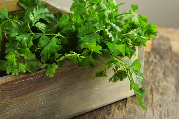 Fresh parsley in box on wooden table — Stock Photo, Image