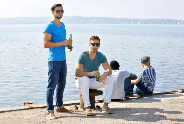 Men talking on the riverside — Stock Photo, Image