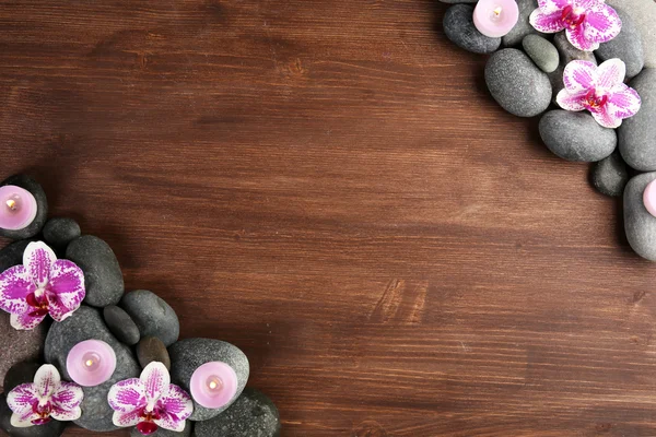 Spa stones and orchid on wooden background — Stock Photo, Image