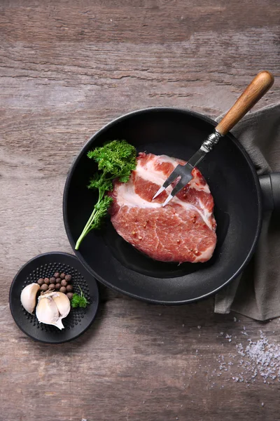 Steak de bœuf marbré sur poêle et épices sur fond bois — Photo