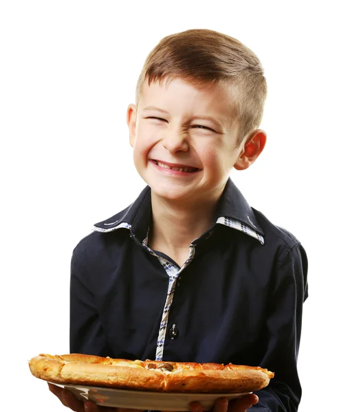 Liten pojke anläggning pizza — Stockfoto