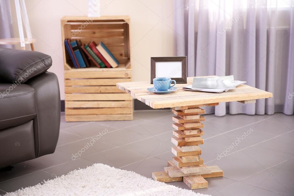 Modern living room interior with coffee table, armchair and stand