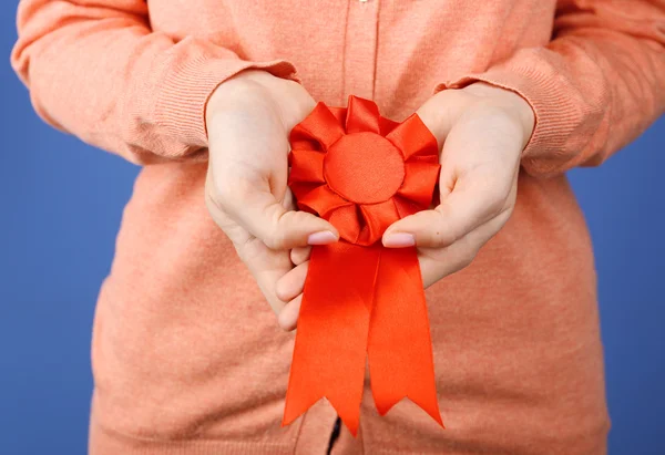 Woman with award ribbon. close-up — Stock Photo, Image