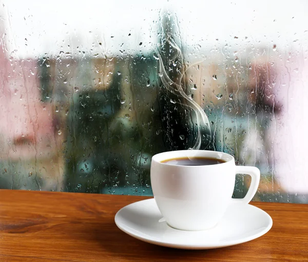 Cup of coffee on window background — Stock Photo, Image