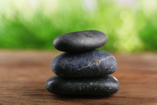 Spa stones on wooden table — Stock Photo, Image