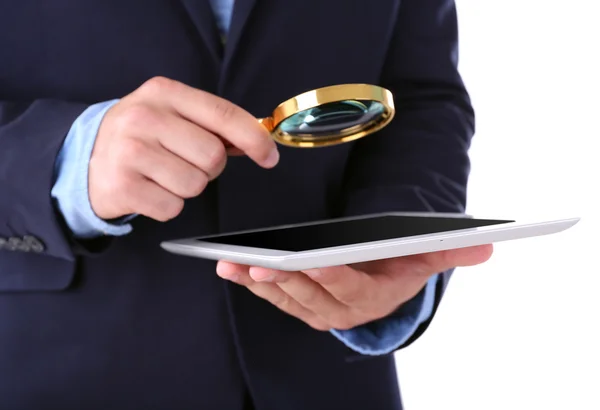 Businessman holding magnifying glass and digital tablet — Stock Photo, Image