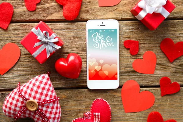 White smart phone with hearts — Stock Photo, Image