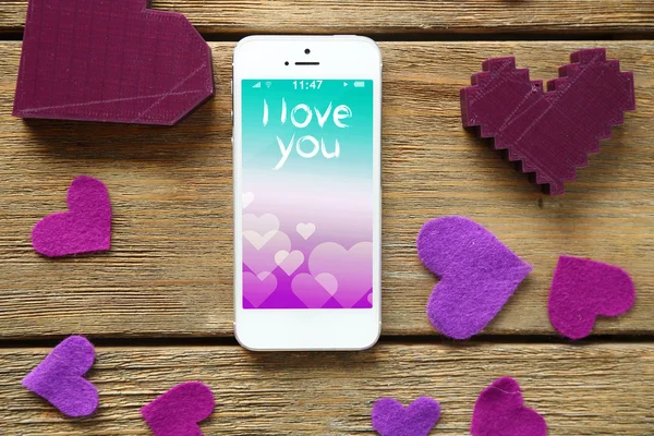 White smart phone with hearts — Stock Photo, Image