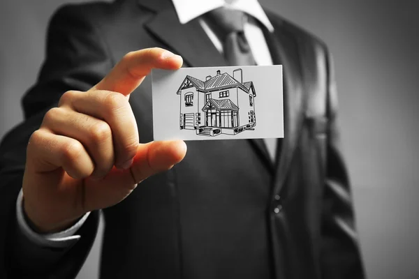 Businessman with house picture — Stock Photo, Image