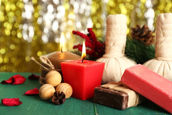 Beautiful Christmas presents composition on green wooden table against sparkle background, close up — Stock Photo, Image