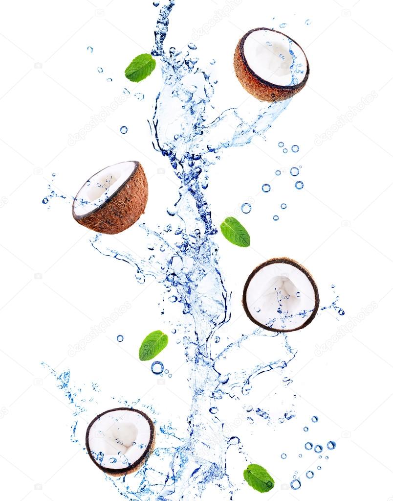 Coconuts and mint leaves in water splashing
