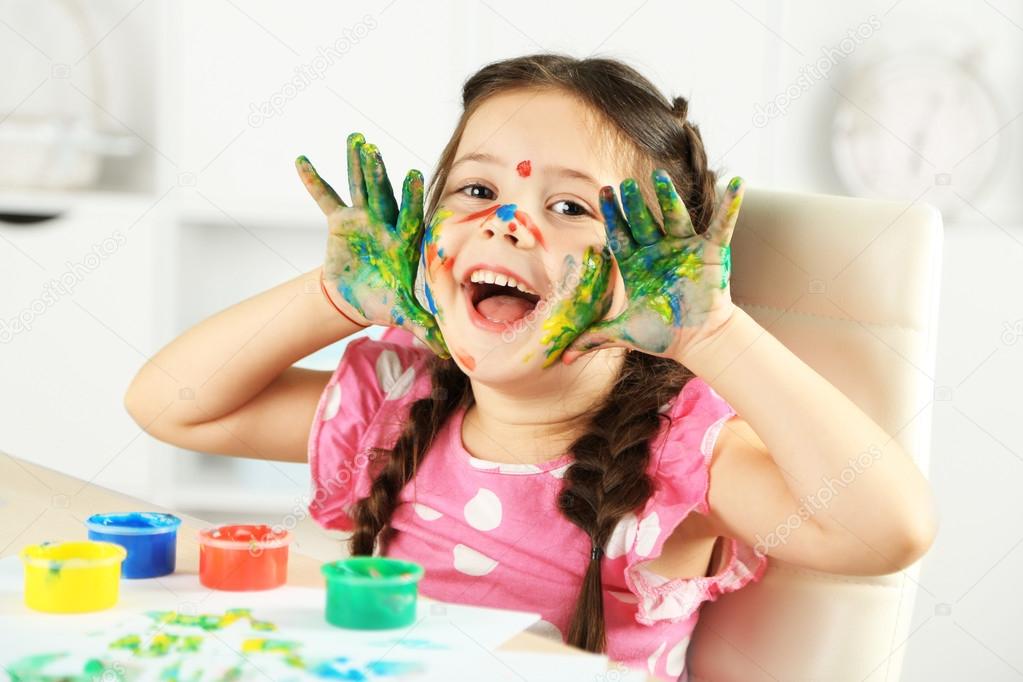 Cute little girl painting picture