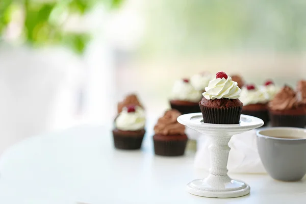 Красиві шоколадні кекси і чашка чаю, на столі — стокове фото