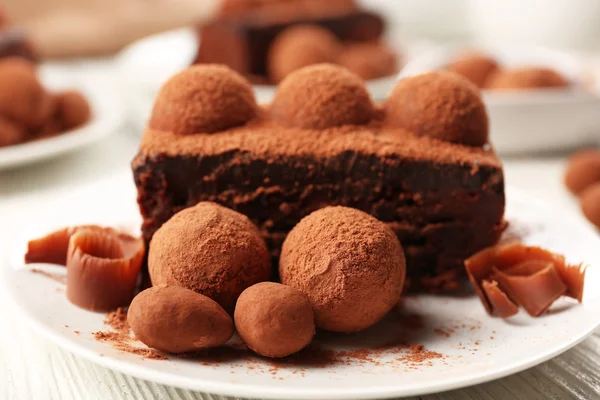 Slices of chocolate cake with a truffle on plate closeup — Stock Photo, Image