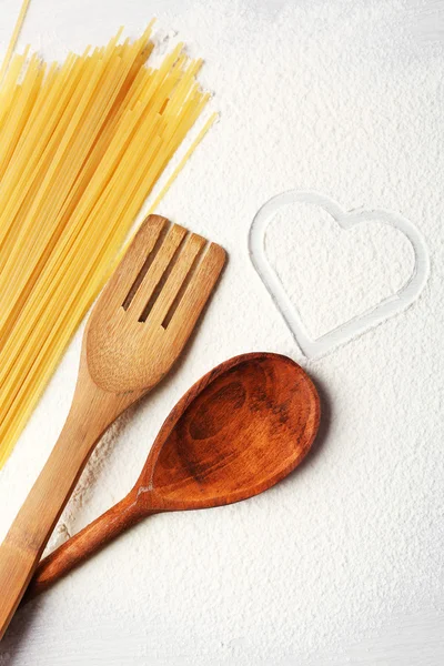 Heart of flour and pasta on gray background — Stock Photo, Image