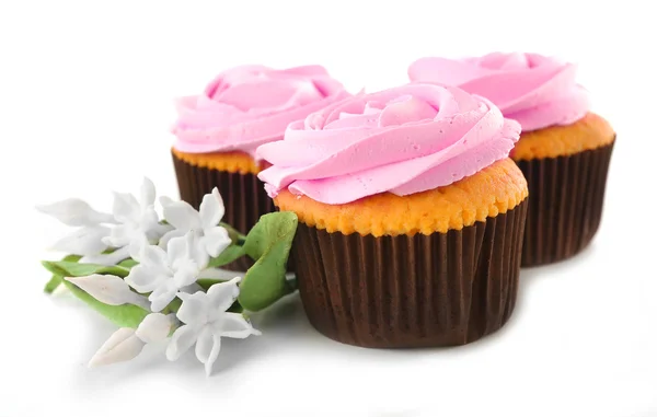Tasty cupcakes with flowers — Stock Photo, Image