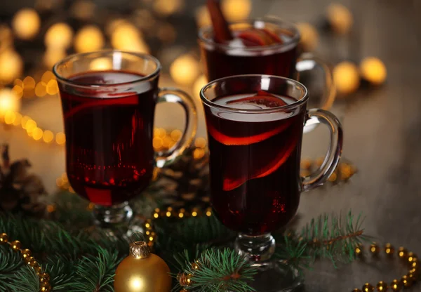 Svařené víno s kořením a vánoční stromeček na dřevěném pozadí — Stock fotografie
