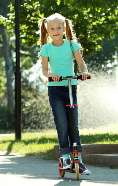 Girl riding on scooter — Stock Photo, Image