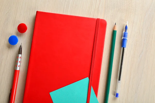 Red notebook with stationery — Stock Photo, Image