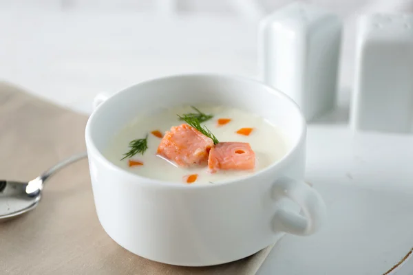 Delicious salmon cream soup on white served table in the restaurant — Stock Photo, Image