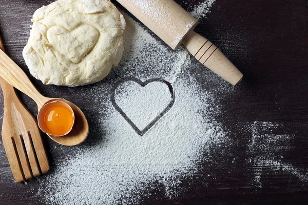 Hjärtat av mjöl, croissant och trä köksredskap på grå bakgrund — Stockfoto