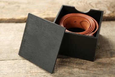 Leather belt with buckle in gift box clipart