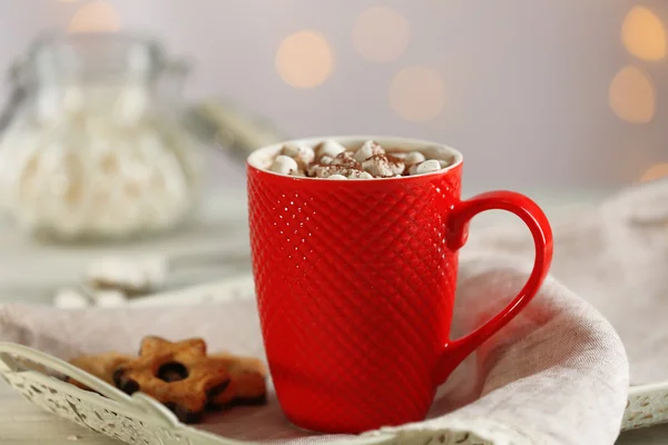 Uma xícara de cacau saboroso e marshmallow no fundo borrado — Fotografia de Stock