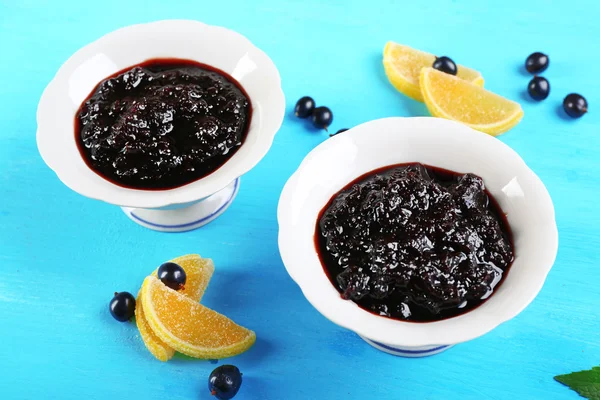 Tasty currant jam with berries on table close up — Stock Photo, Image