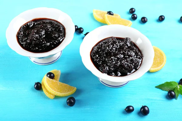 Tasty currant jam with berries on table close up — Stock Photo, Image