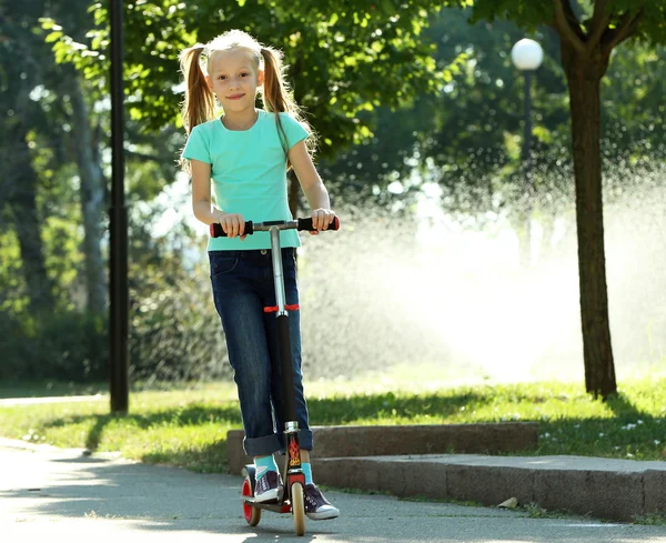 Girl riding on scooter — Stock Photo, Image