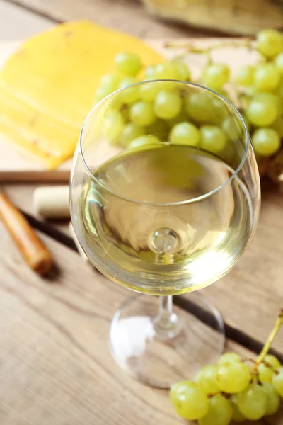 Still life of wine, grape, cheese and bread on rustic wooden background — Stock Photo, Image