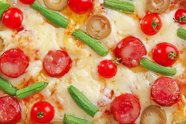 Välsmakande pizza bakgrund, makro — Stockfoto