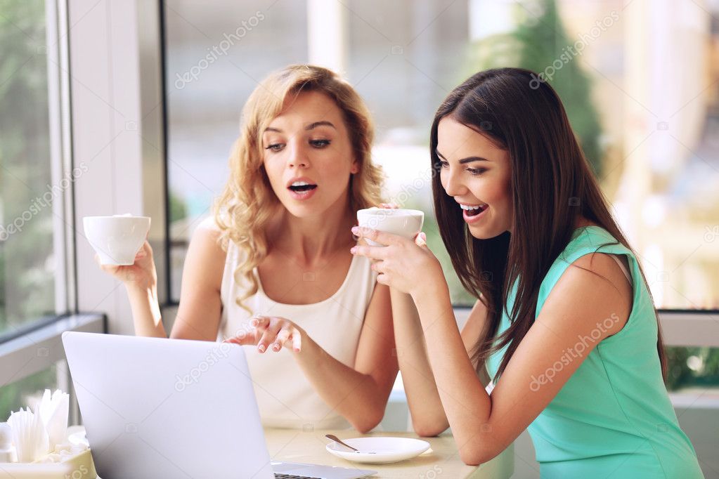 women with laptop in cafe