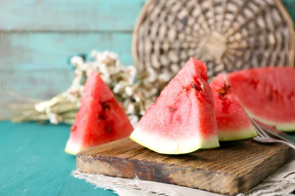 Sliced watermelon on decorated wooden background — Stock Photo, Image