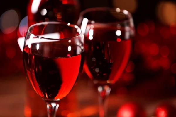 Wine glasses with Christmas decorations on wooden table, close up — Stock Photo, Image