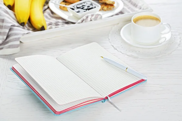 Healthy breakfast and opened notebook — Stock Photo, Image