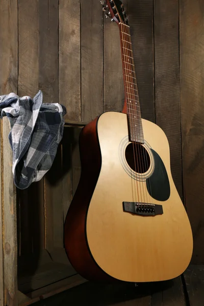 Guitar and shirt left on crate — Stock Photo, Image