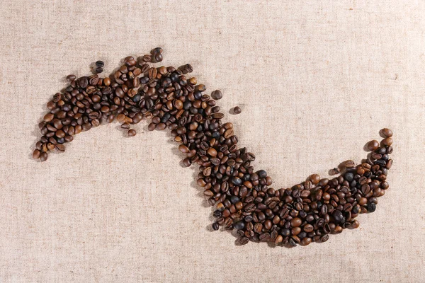 Figure of roasted coffee beans on the linen fabric — Stock Photo, Image