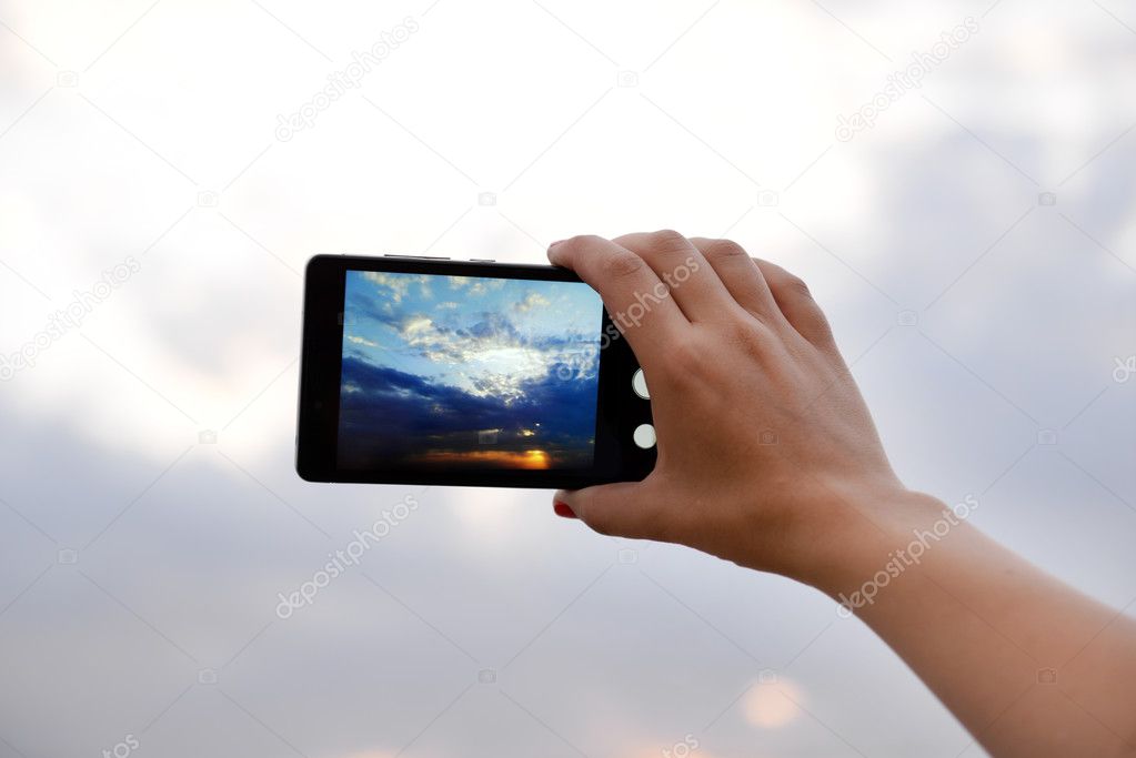 Man using smart phone for taking photo 