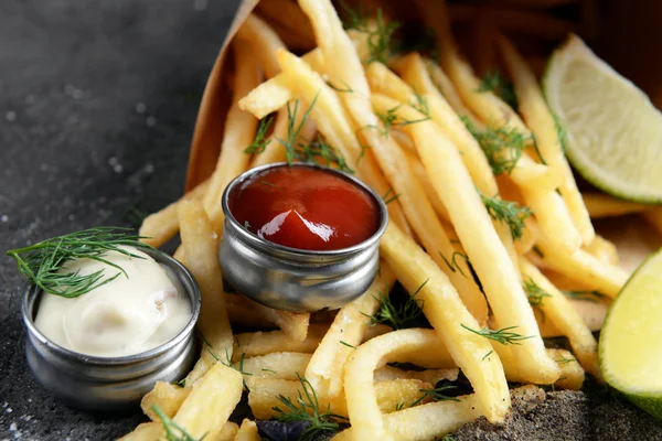 French fries in bag with sauce — Stock Photo, Image