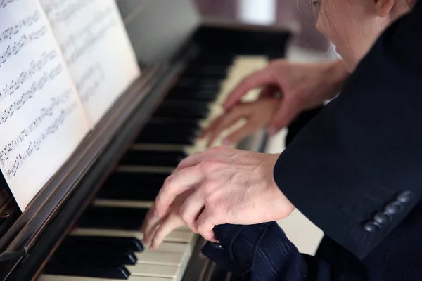 Musician man and girl playing piano — Stock Photo, Image