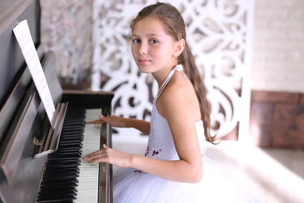 Prinses meisje speelt piano — Stockfoto