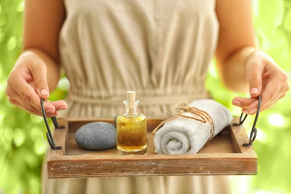 Hands with tray of spa products — Stock Photo, Image