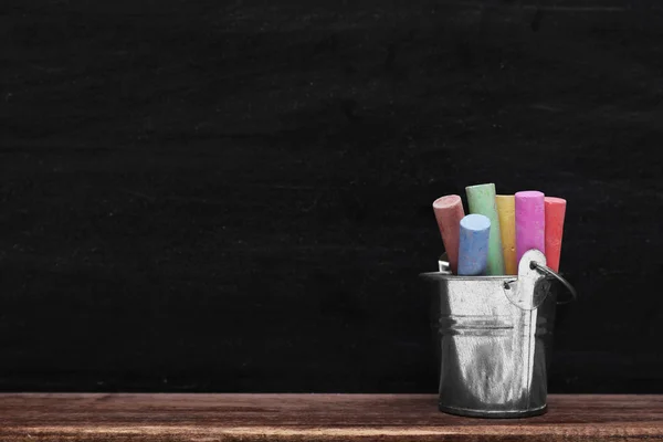 Multicoloured chalk in metal bucket — Stock Photo, Image