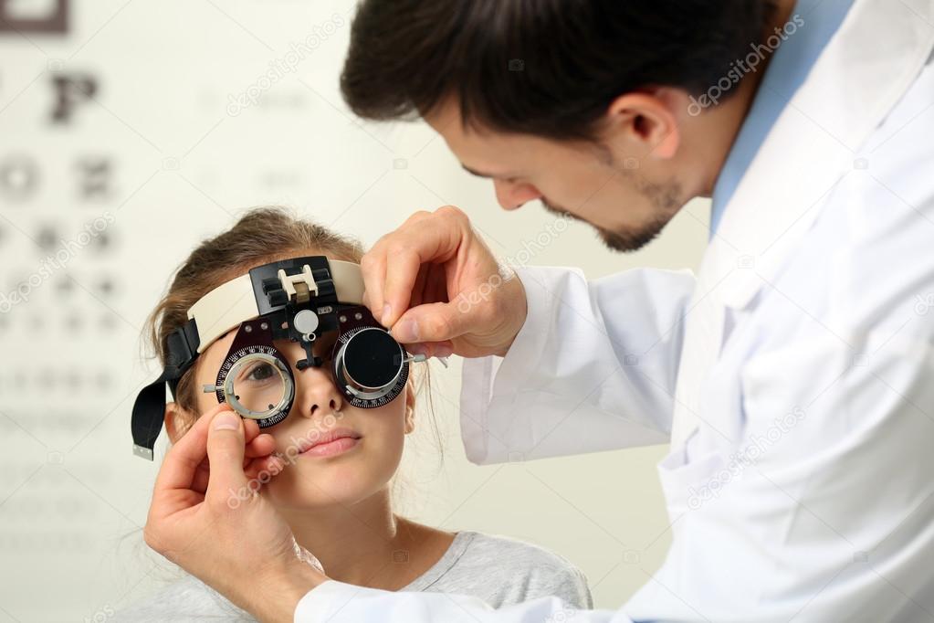 Male doctor examing girl patient